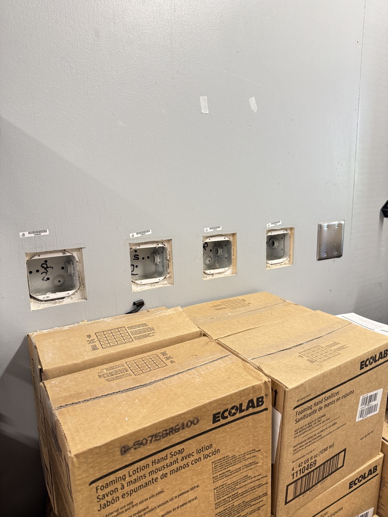 Low-voltage rough-in outlet boxes mounted in drywall ready for device install