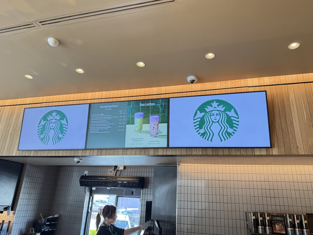 Commercial digital signage installation with overhead camera